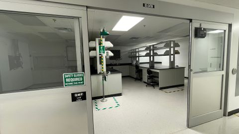 Lab workspace with ample counter spaces and storage that requires safety glasses