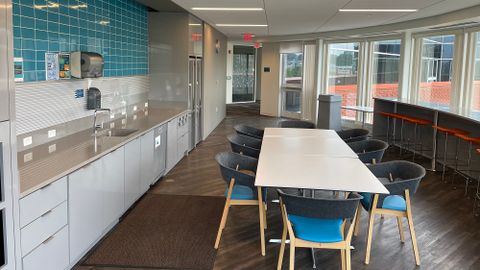 Indoor break room with high-top seating, table seating and counter space