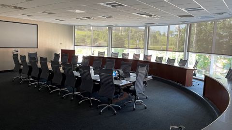 A large conference room with lots of seating both in the center and around the room