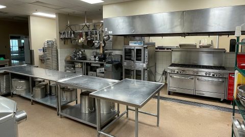 Large kitchen with pots, pans, utensils, stoves, ovens and more